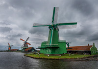 Three Zaanse Schans windmills on the banks of the Zaan river