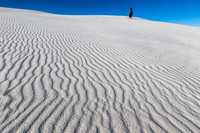 Gypsum sand dune with woman in black