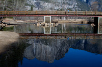 Lone tourist and  Yosemite falls reflection