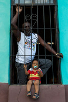 Man and boy in window, Trinidad Cuba