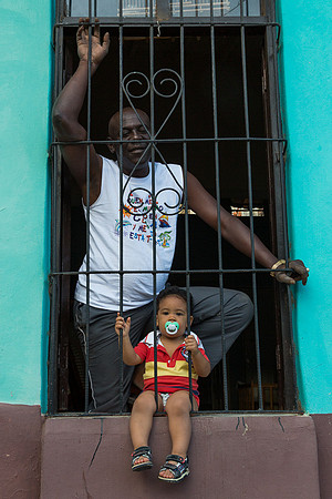 Man and boy in window, Trinidad Cuba