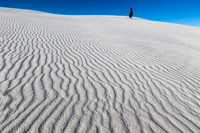 Gypsum sand dune with woman in black