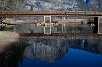 Lone tourist and  Yosemite falls reflection