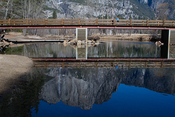 Lone tourist and  Yosemite falls reflection