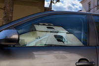 Reflection of Duomo di San Lorenzo bell tower in car window
